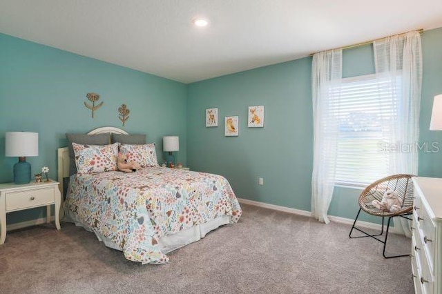 bedroom with baseboards and carpet