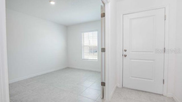 spare room with baseboards