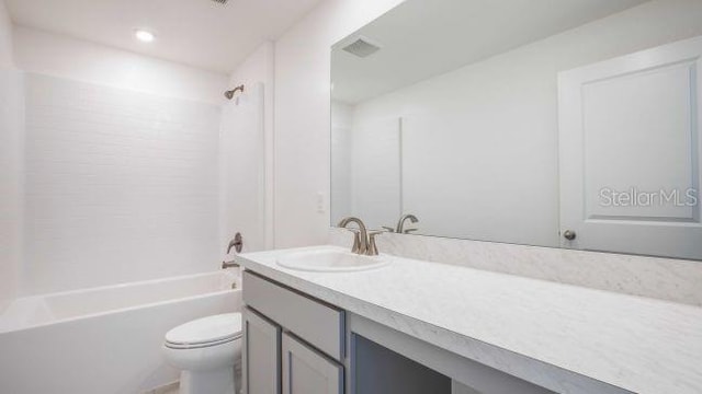 full bathroom featuring vanity, toilet, visible vents, and shower / bath combination