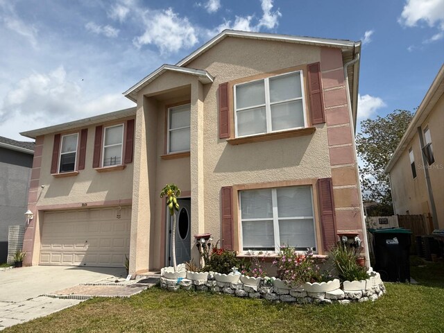 3024 Natoma Way, Orlando, FL 32825 - multi unit property featuring stucco siding, a garage, driveway, and a front lawn