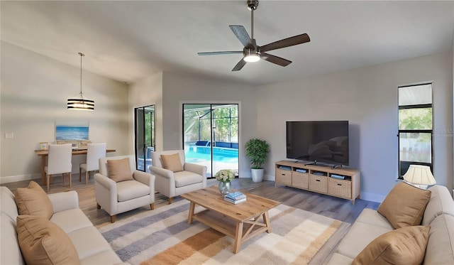 213 Almaden Ct, Winter Springs, FL 32708 - living area featuring lofted ceiling, light wood-style floors, ceiling fan, and a healthy amount of sunlight