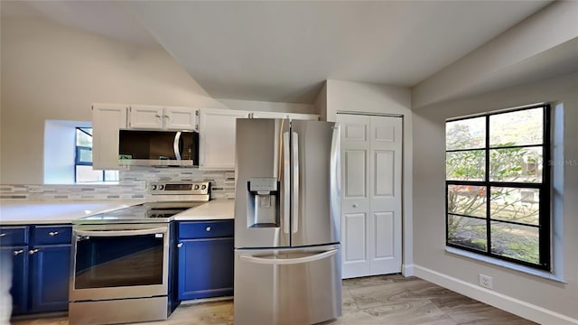 213 Almaden Ct, Winter Springs, FL 32708 - kitchen with light countertops, stainless steel appliances, lofted ceiling, blue cabinets, and backsplash