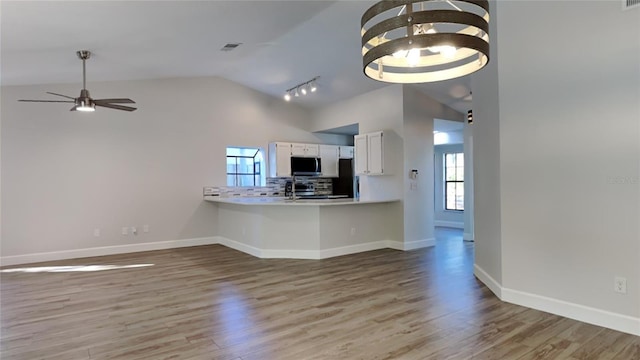 213 Almaden Ct, Winter Springs, FL 32708 - kitchen featuring stainless steel microwave, plenty of natural light, vaulted ceiling, and wood finished floors