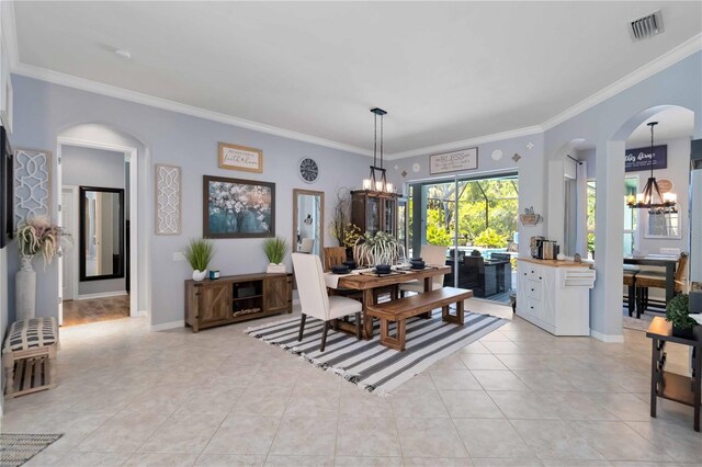 13136 Peregrin Cir, Bradenton, FL 34212 - dining space with a chandelier, arched walkways, crown molding, and light tile patterned flooring