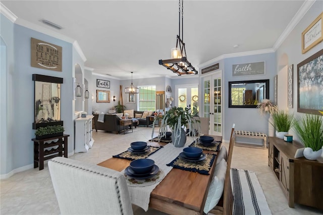 13136 Peregrin Cir, Bradenton, FL 34212 - dining space featuring light tile patterned floors, a chandelier, ornamental molding, and french doors
