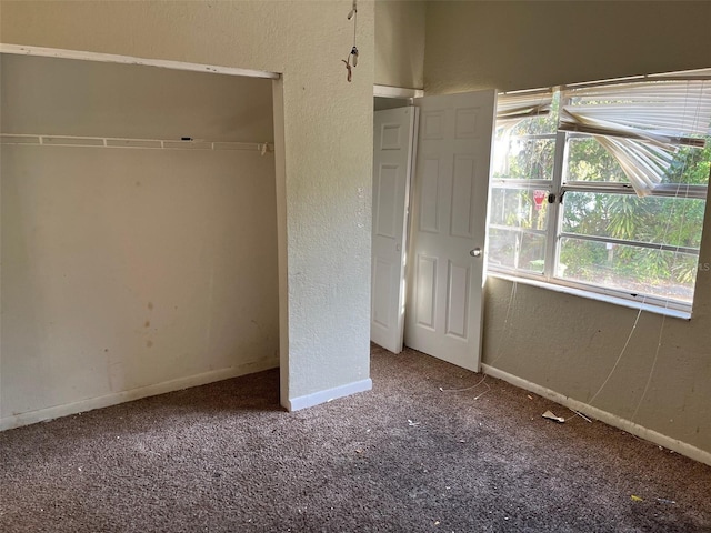 2918 E Waters Ave, Tampa, FL 33604 - unfurnished bedroom with carpet flooring, a textured wall, baseboards, and a closet