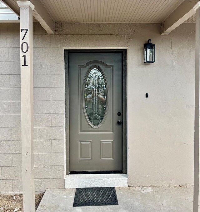 701 N 4th St, Haines City, FL 33844 - doorway to property featuring concrete block siding