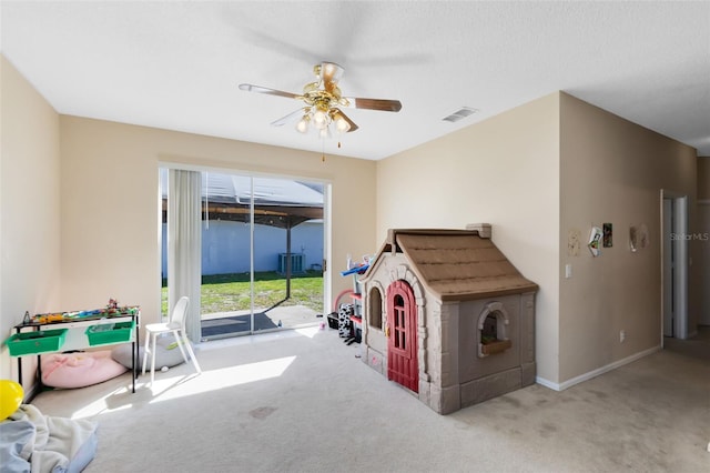 recreation room featuring visible vents, baseboards, ceiling fan, and carpet floors