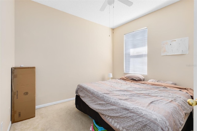 carpeted bedroom featuring a ceiling fan and baseboards