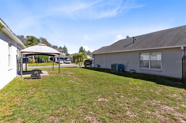 view of yard with a gazebo and central AC unit