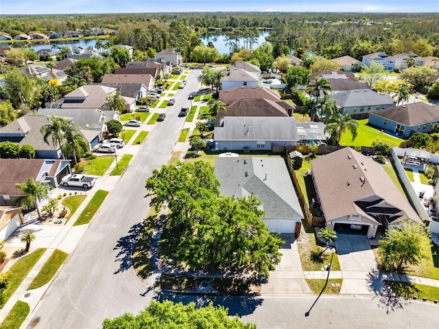 bird's eye view featuring a residential view, a forest view, and a water view