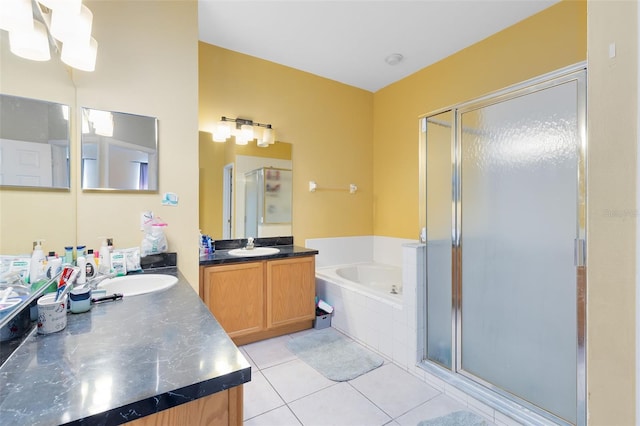 full bathroom with two vanities, a sink, a shower stall, a garden tub, and tile patterned floors