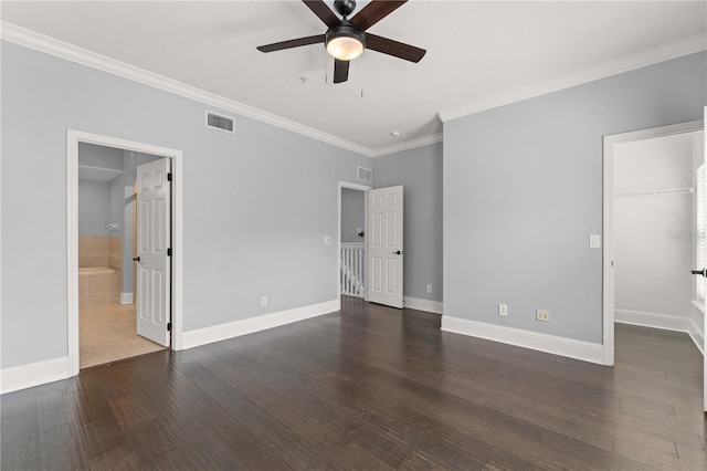 1563 Common Way Rd, Orlando, FL 32814 - unfurnished bedroom with crown molding, a walk in closet, wood finished floors, connected bathroom, and ceiling fan