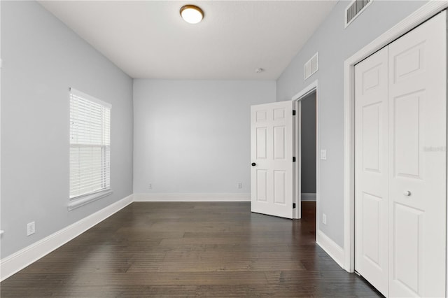 1563 Common Way Rd, Orlando, FL 32814 - unfurnished bedroom with a closet and dark wood finished floors