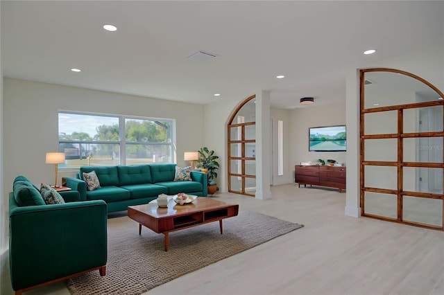 living room with visible vents, recessed lighting, and light wood-style floors