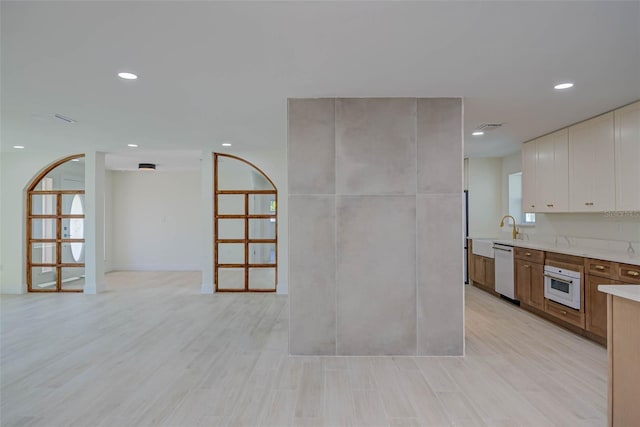 kitchen featuring white cabinets, light countertops, white appliances, and recessed lighting