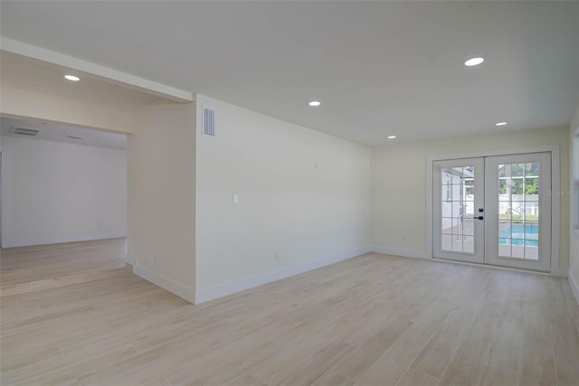 unfurnished room featuring recessed lighting, light wood finished floors, visible vents, french doors, and baseboards