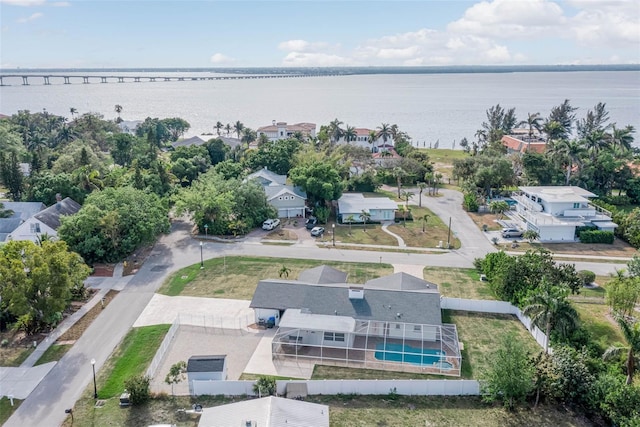 drone / aerial view featuring a residential view and a water view