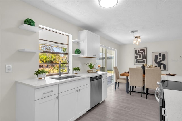 kitchen featuring white cabinets, a sink, open shelves, and appliances with stainless steel finishes