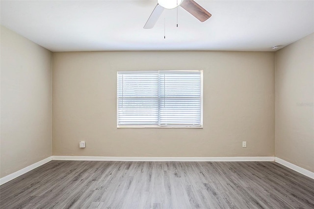 3645 6th St S, Saint Petersburg, FL 33705 - empty room featuring wood finished floors, baseboards, and ceiling fan
