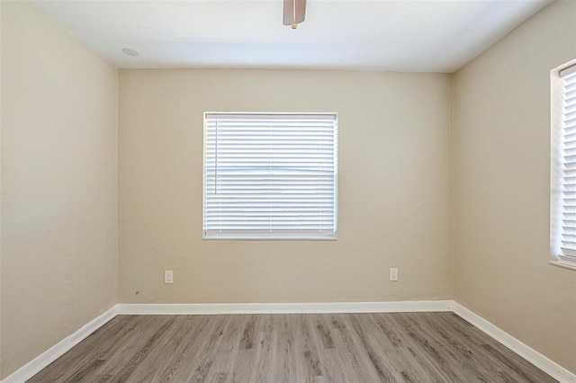 3645 6th St S, Saint Petersburg, FL 33705 - unfurnished room featuring baseboards, a healthy amount of sunlight, and light wood-type flooring