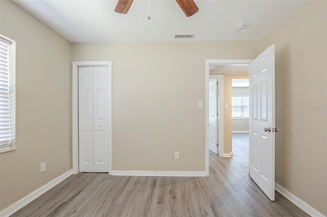 3645 6th St S, Saint Petersburg, FL 33705 - unfurnished bedroom with a closet, visible vents, baseboards, ceiling fan, and light wood-style floors