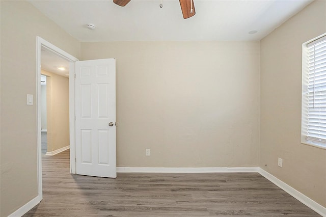 3645 6th St S, Saint Petersburg, FL 33705 - empty room featuring baseboards, wood finished floors, and a ceiling fan