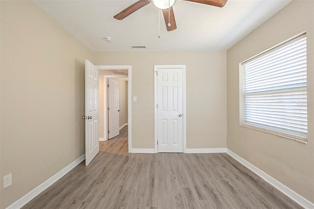 3645 6th St S, Saint Petersburg, FL 33705 - unfurnished bedroom featuring ceiling fan, baseboards, light wood finished floors, and visible vents