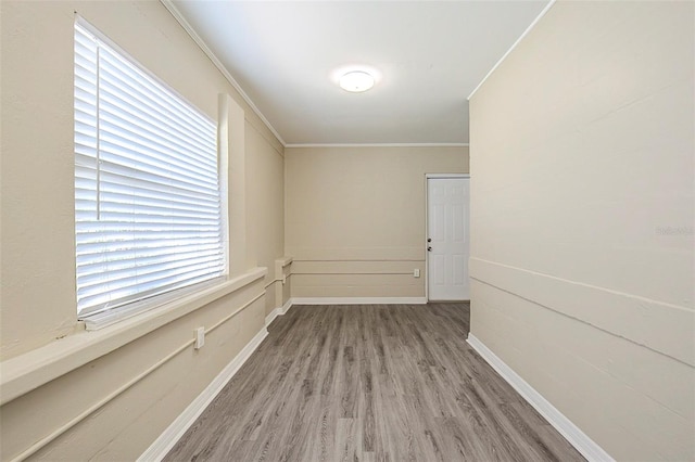 3645 6th St S, Saint Petersburg, FL 33705 - empty room featuring baseboards, crown molding, and wood finished floors