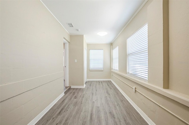 3645 6th St S, Saint Petersburg, FL 33705 - hall with baseboards, ornamental molding, visible vents, and wood finished floors