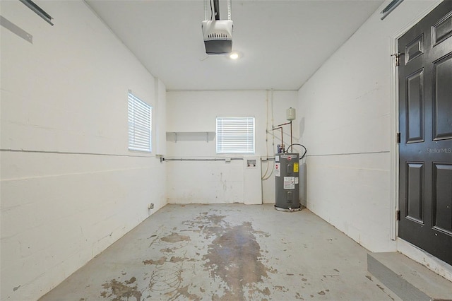 3645 6th St S, Saint Petersburg, FL 33705 - garage featuring electric water heater and a garage door opener