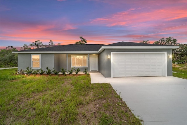 single story home with stucco siding, concrete driveway, a garage, and roof with shingles