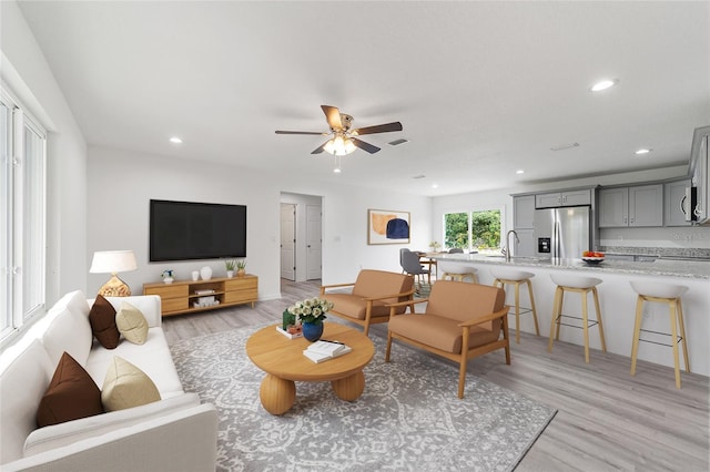 living area featuring visible vents, recessed lighting, light wood-style floors, and ceiling fan