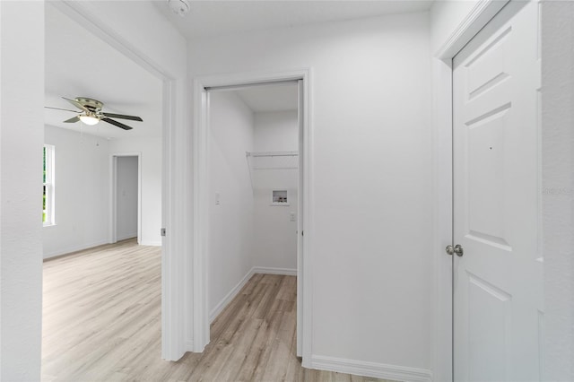 hallway with baseboards and light wood finished floors