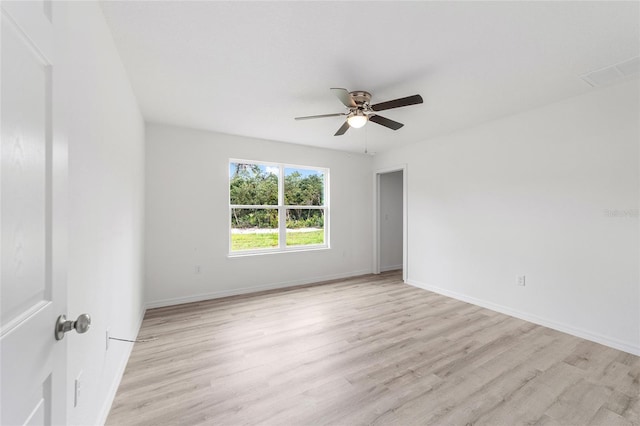 unfurnished room featuring baseboards, light wood-style floors, and ceiling fan
