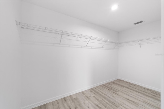 walk in closet featuring visible vents and light wood-style floors