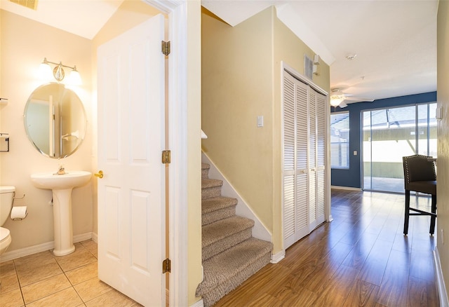 6274 Bristol Channel Way, Orlando, FL 32829 - staircase with visible vents, wood finished floors, a ceiling fan, and baseboards