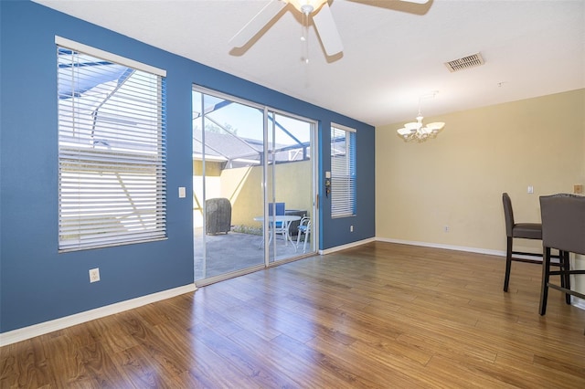 6274 Bristol Channel Way, Orlando, FL 32829 - dining space with visible vents, ceiling fan with notable chandelier, baseboards, and wood finished floors