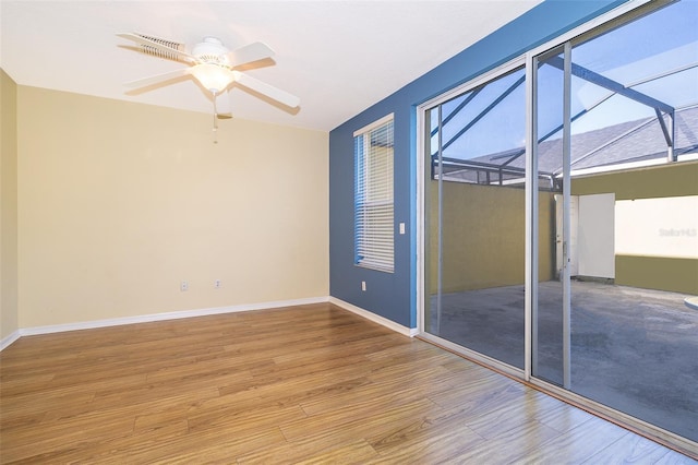 6274 Bristol Channel Way, Orlando, FL 32829 - empty room featuring a wealth of natural light, baseboards, a ceiling fan, and wood finished floors