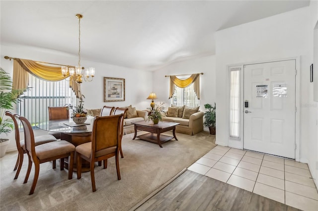 dining room featuring light wood finished floors and a chandelier