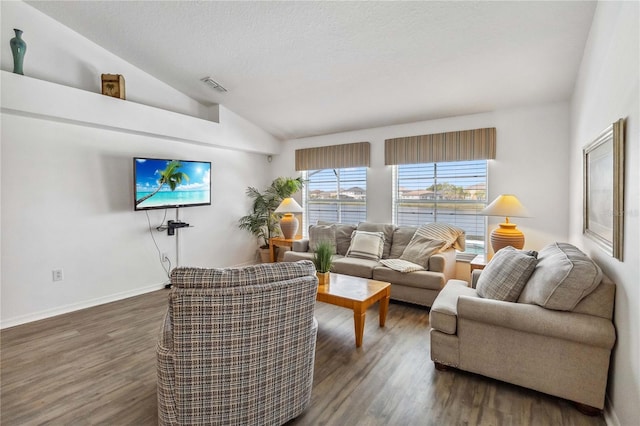 living room featuring vaulted ceiling, wood finished floors, a textured ceiling, baseboards, and visible vents