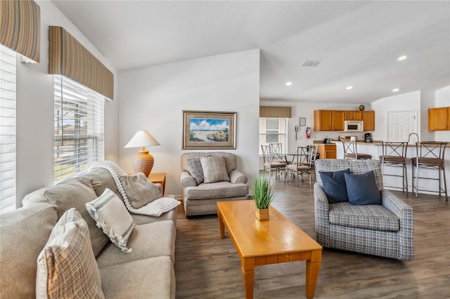 living area featuring lofted ceiling, recessed lighting, and dark wood-style flooring