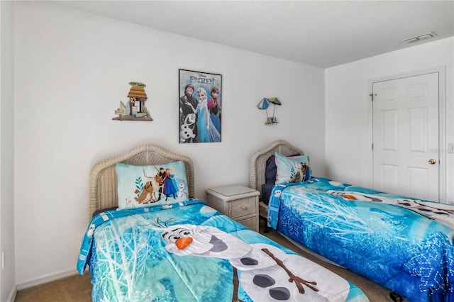 bedroom with baseboards, visible vents, and carpet