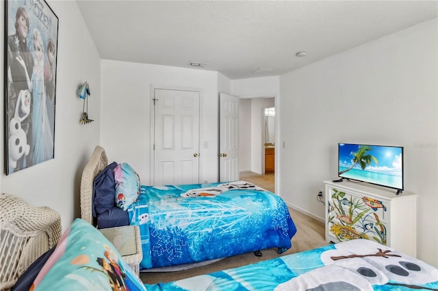bedroom with baseboards and visible vents