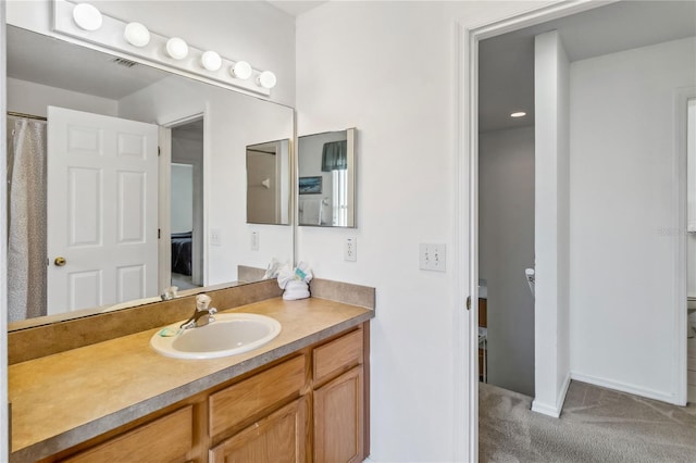 full bathroom featuring toilet, vanity, ensuite bathroom, baseboards, and visible vents