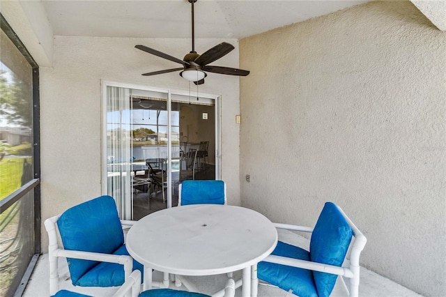 sunroom featuring outdoor dining area and ceiling fan