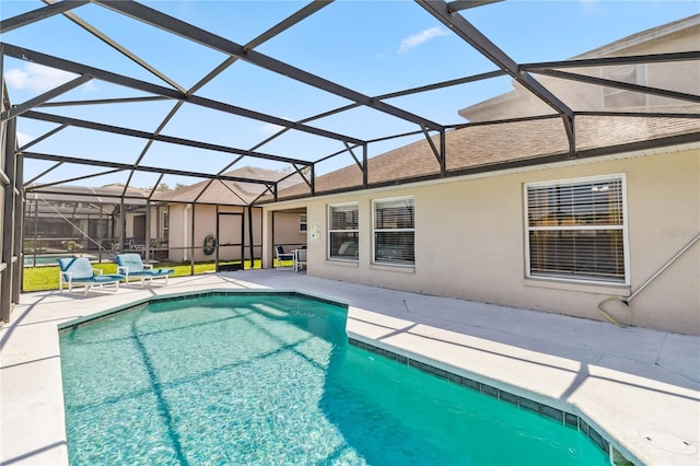outdoor pool with a lanai and a patio area