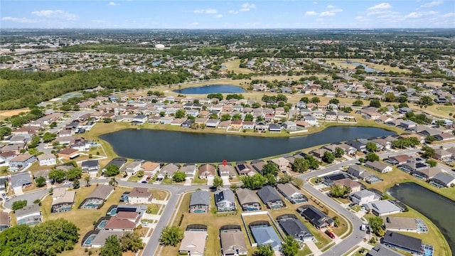 drone / aerial view with a residential view and a water view