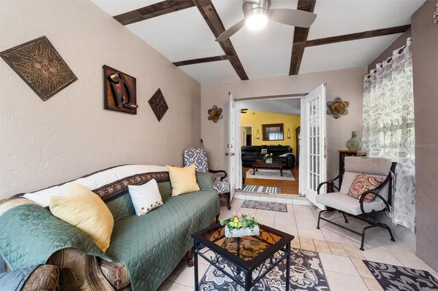 living area with beamed ceiling, light tile patterned floors, french doors, and a ceiling fan