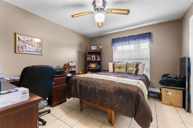 bedroom with a textured ceiling, a ceiling fan, and light tile patterned floors